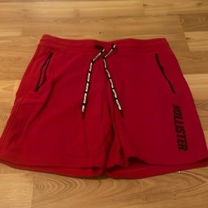 Hollister red shorts with black text, medium